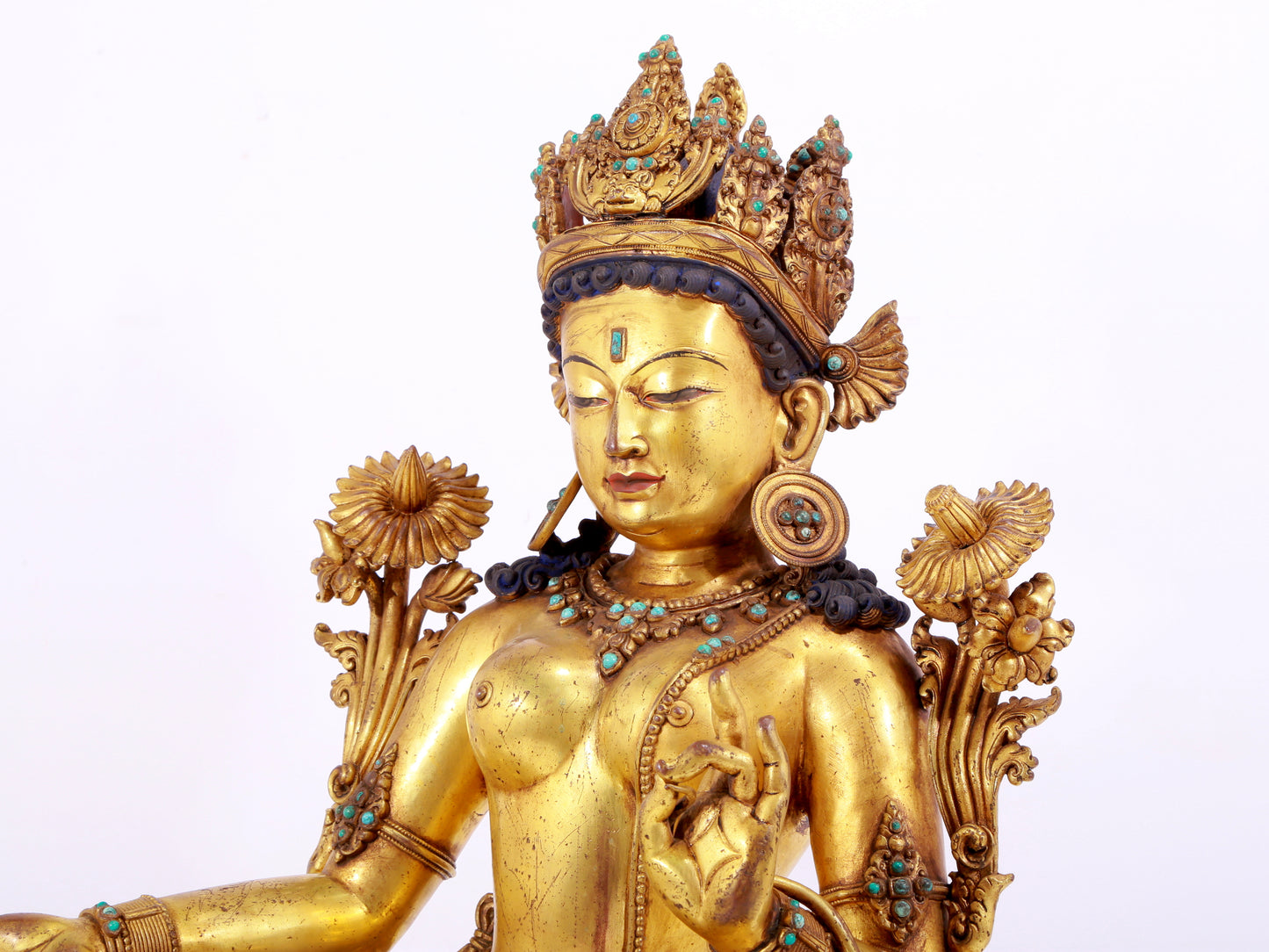 A solemn gilt copper inlaid turquoise green Tara statue