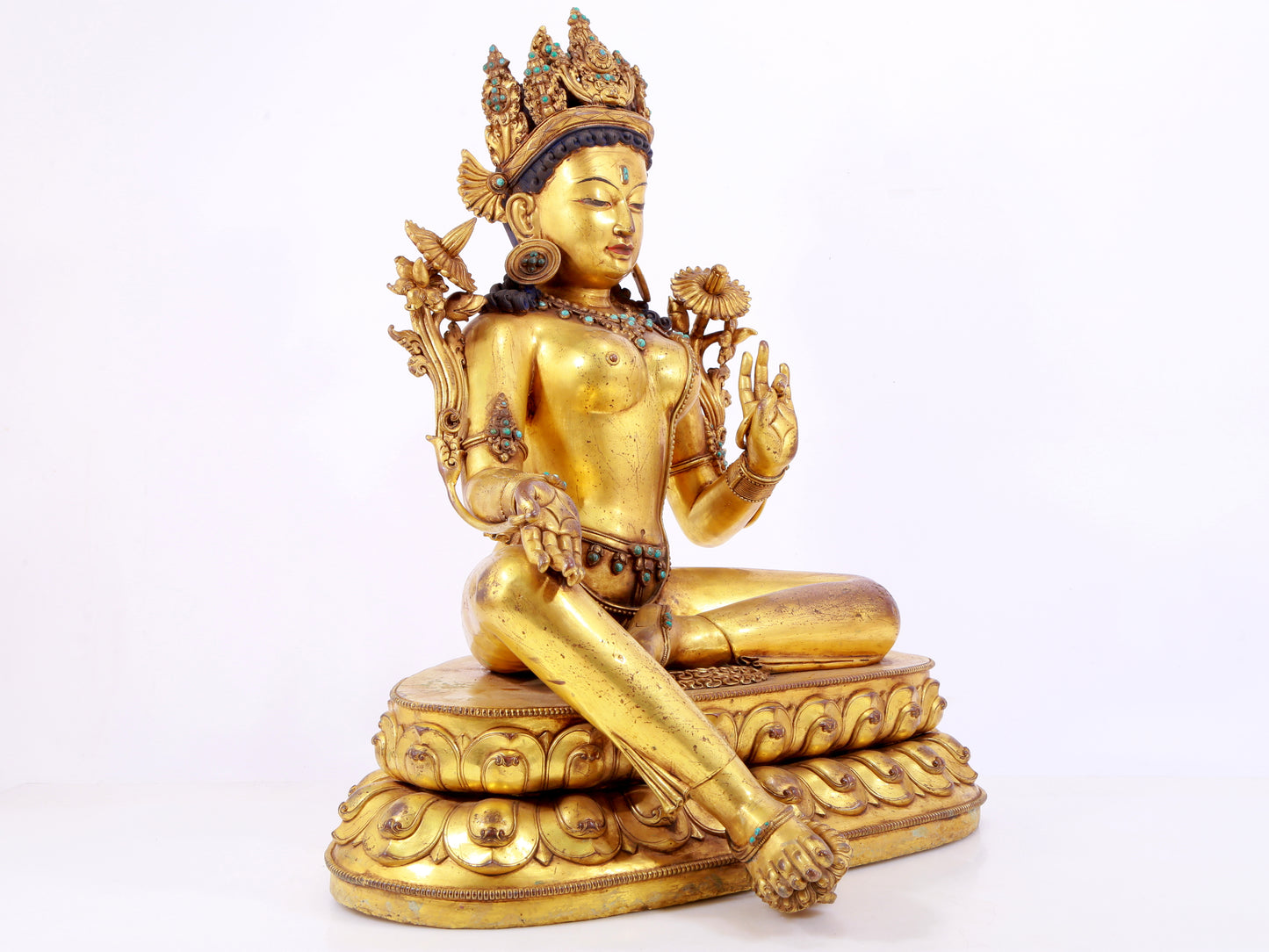 A solemn gilt copper inlaid turquoise green Tara statue