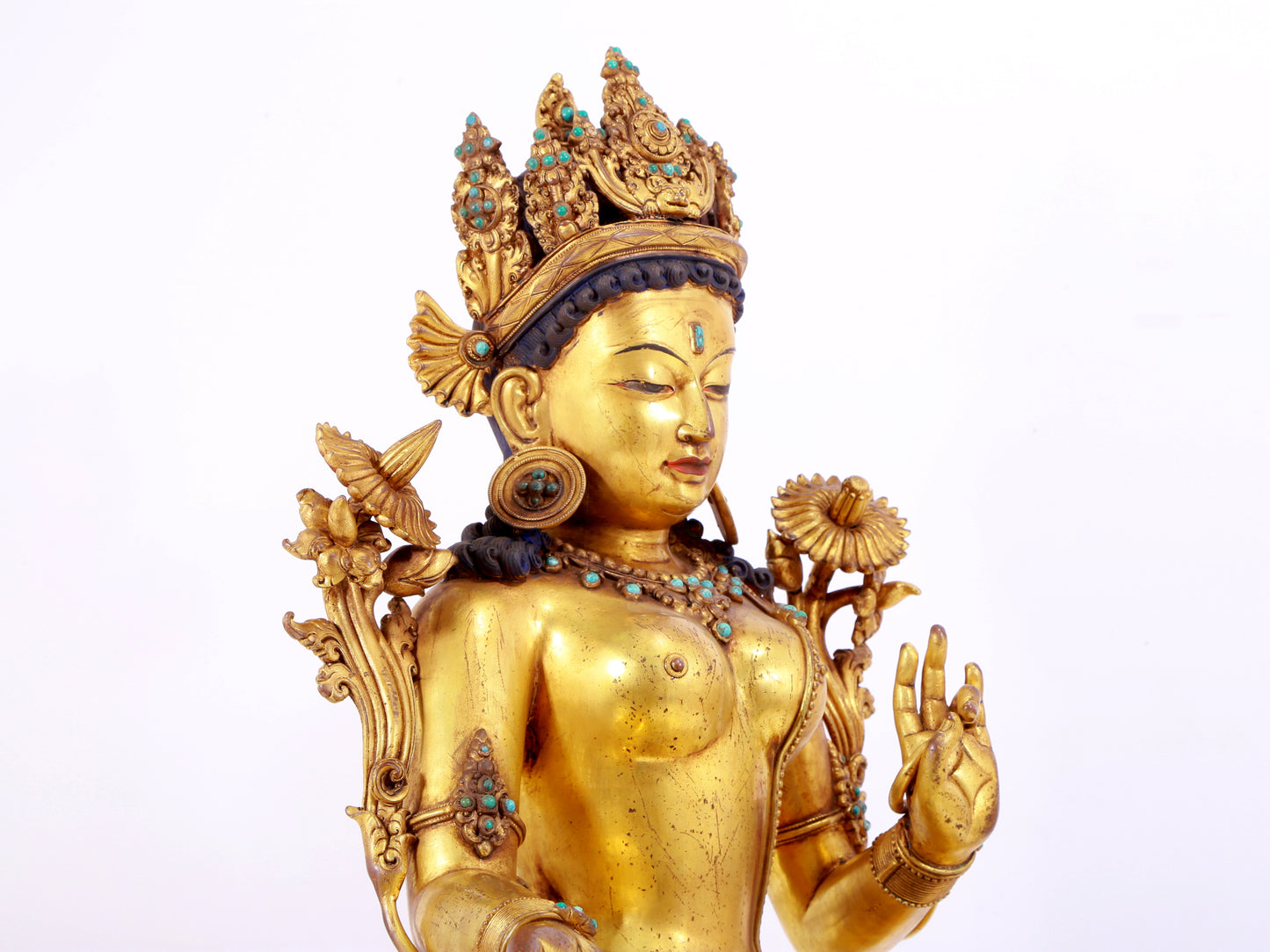A solemn gilt copper inlaid turquoise green Tara statue