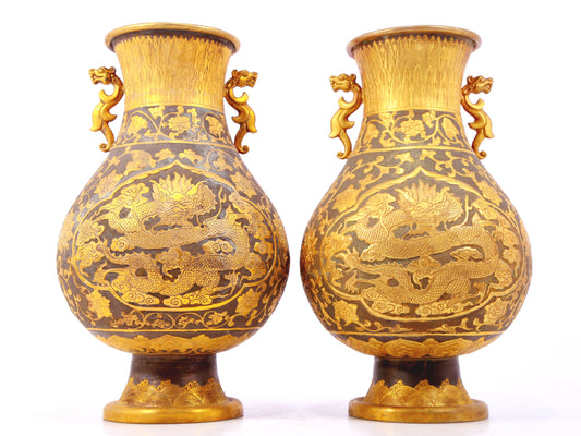 A perfect pair of gilt bronze and silver amphora with lotus and dragon patterns