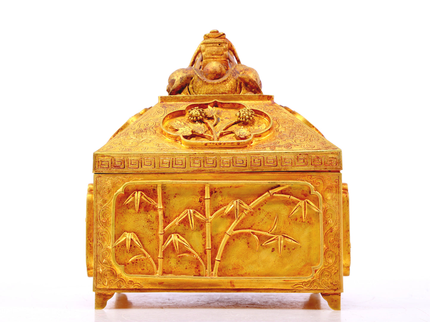 A gilt bronze Buddha box with floral and dragon patterns