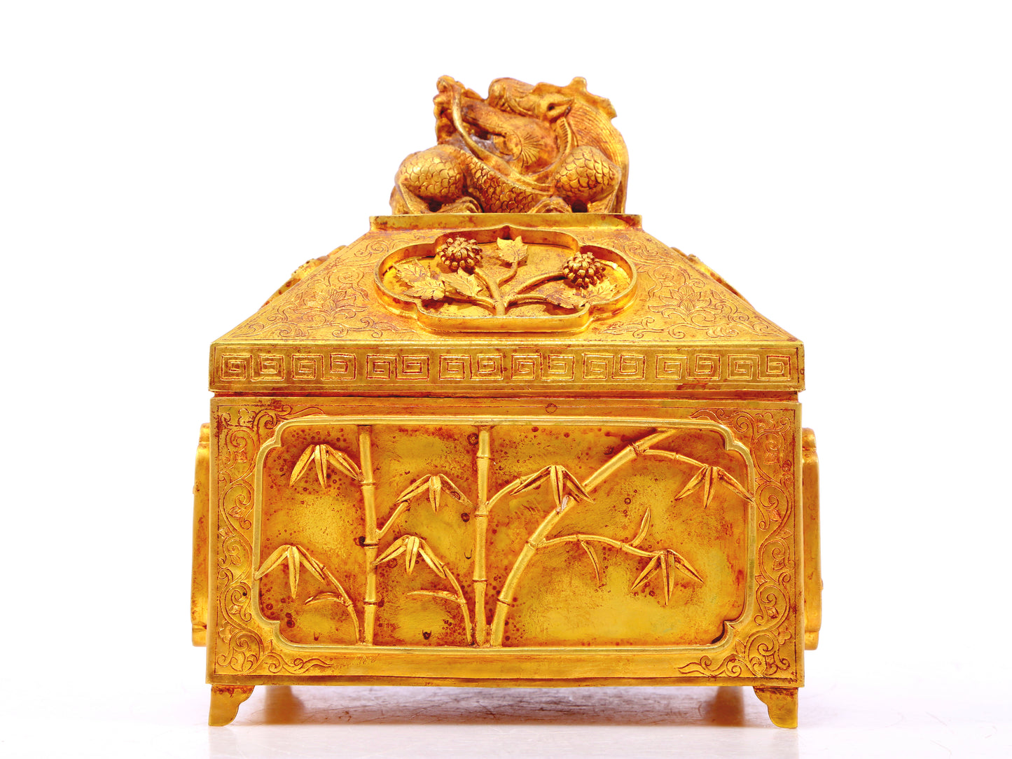 A gilt bronze Buddha box with floral and dragon patterns