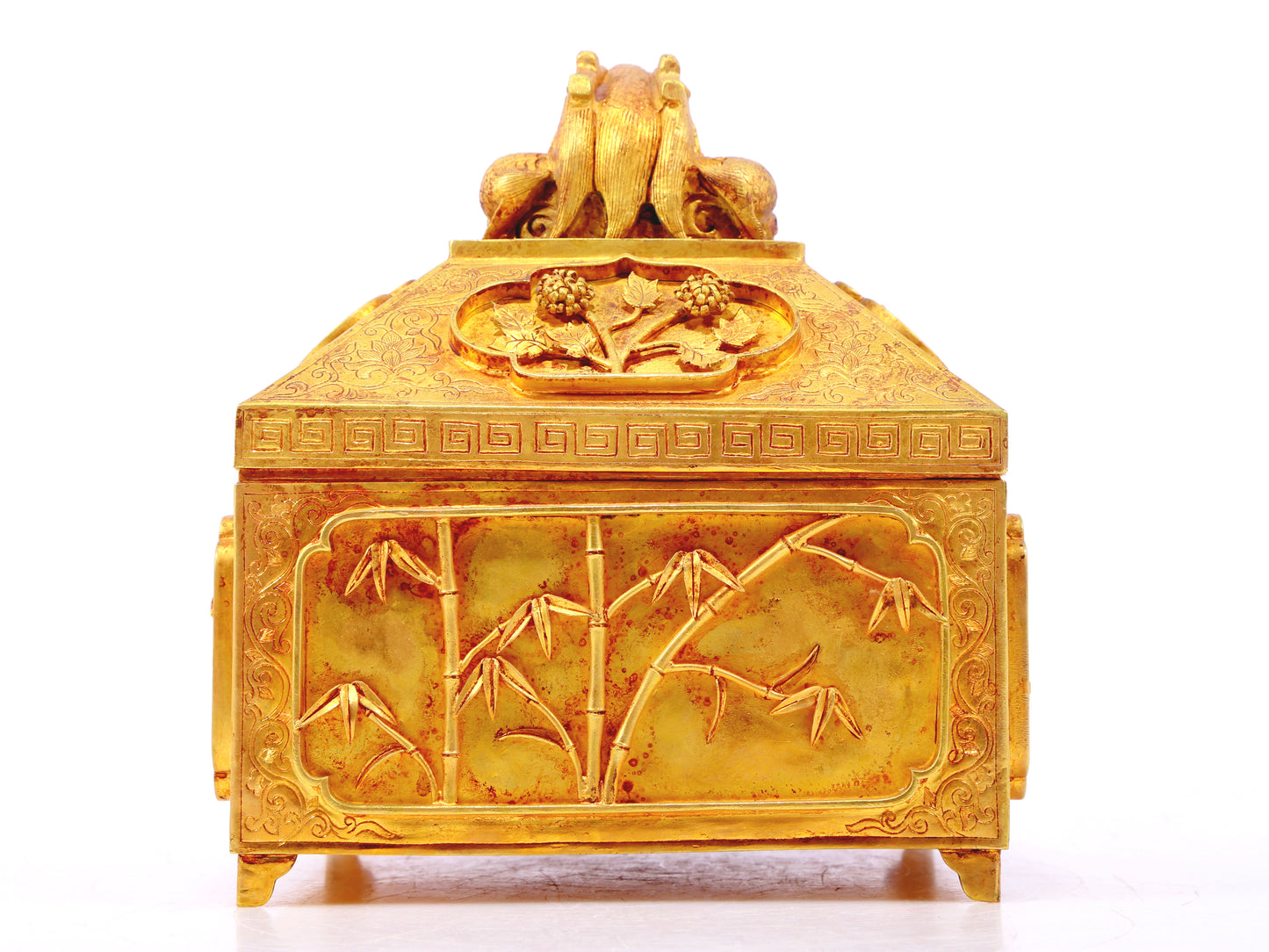 A gilt bronze Buddha box with floral and dragon patterns