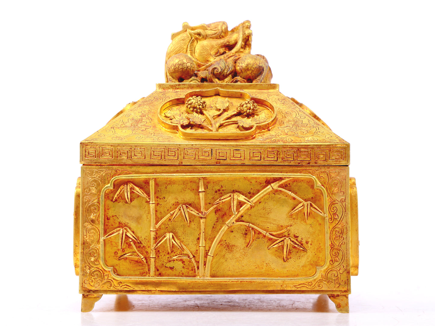 A gilt bronze Buddha box with floral and dragon patterns