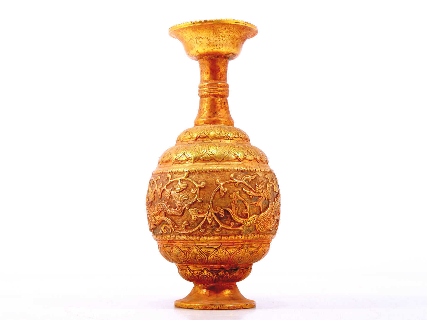 An exquisite gilt bronze vase with lotus and dragon patterns wrapped around branches.