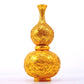 An exquisite gilt bronze gourd vase with lotus and dragon patterns.