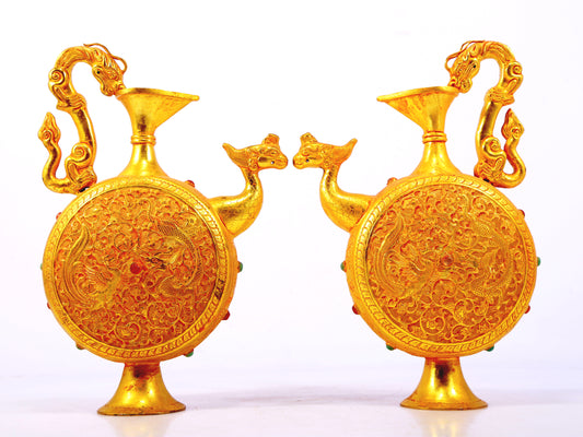 A pair of exquisite gilt bronze ewers inlaid with treasures, lotus branches and dragon and phoenix patterns, with