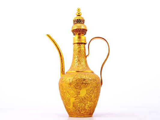 An exquisite gilt bronze ewer with lotus and phoenix patterns wrapped around branches