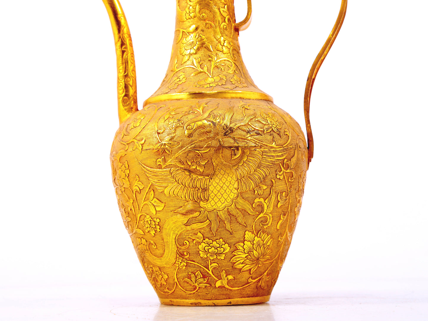 An exquisite gilt bronze ewer with lotus and phoenix patterns wrapped around branches