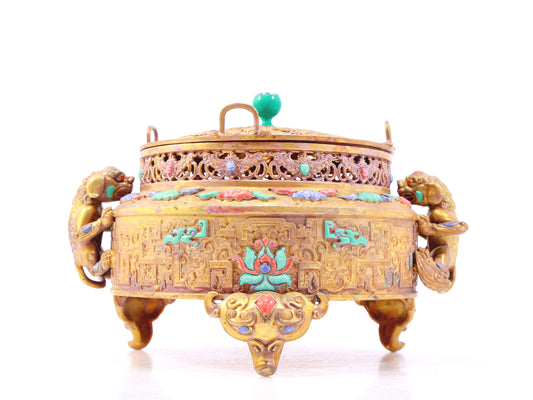 An exquisite gilt bronze censer with two ears and three legs inlaid with treasures, lotus branches and dragon and phoenix patterns.