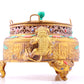 An exquisite gilt bronze censer with two ears and three legs inlaid with treasures, lotus branches and dragon and phoenix patterns.