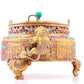 An exquisite gilt bronze censer with two ears and three legs inlaid with treasures, lotus branches and dragon and phoenix patterns.