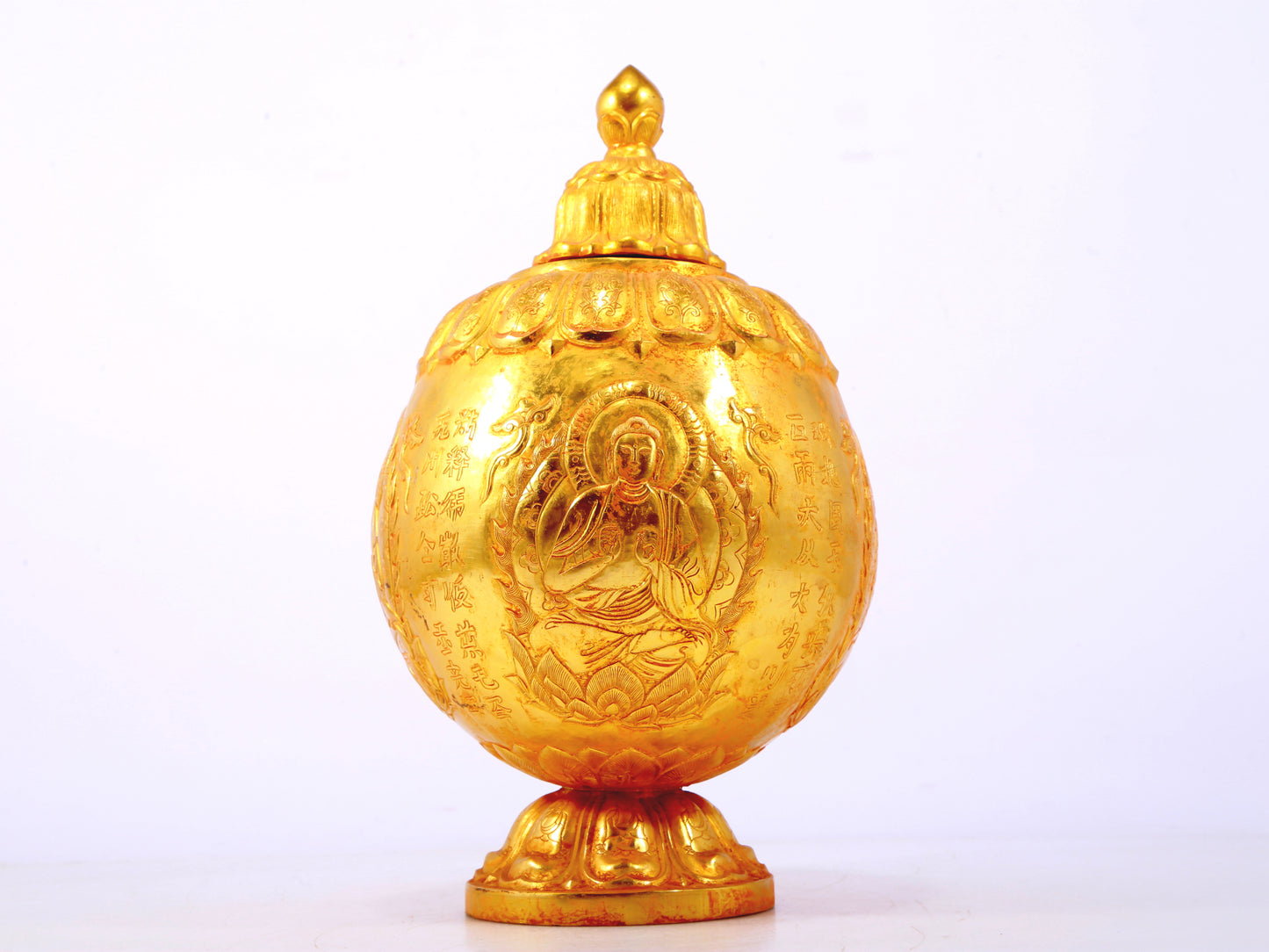 An exquisite gilt bronze jar with image of Gautama Buddha