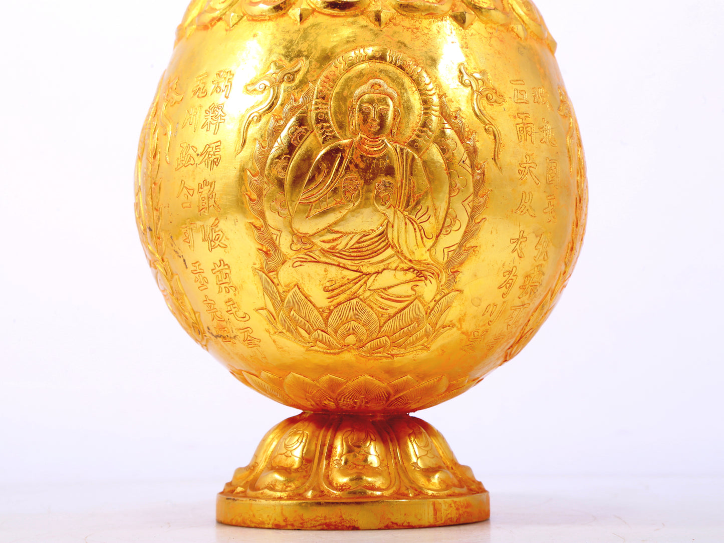 An exquisite gilt bronze jar with image of Gautama Buddha