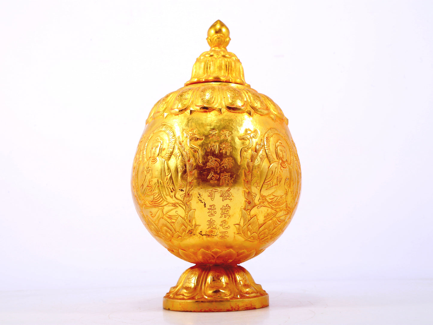 An exquisite gilt bronze jar with image of Gautama Buddha