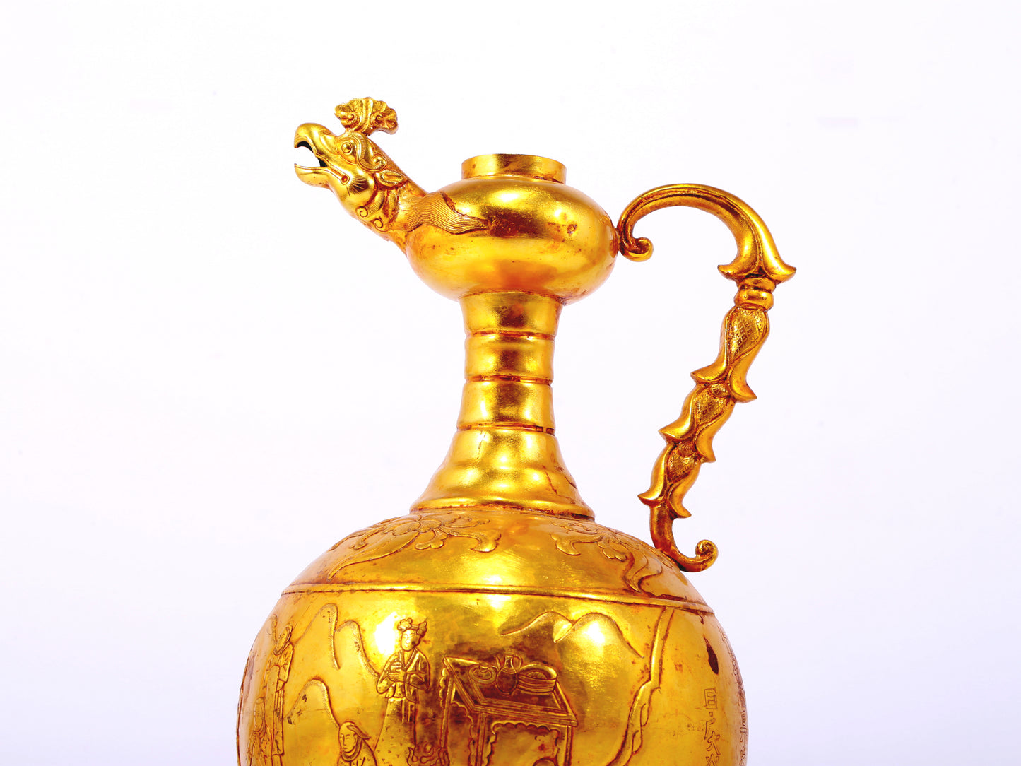 An exquisite gilt bronze landscape figure holding a pot