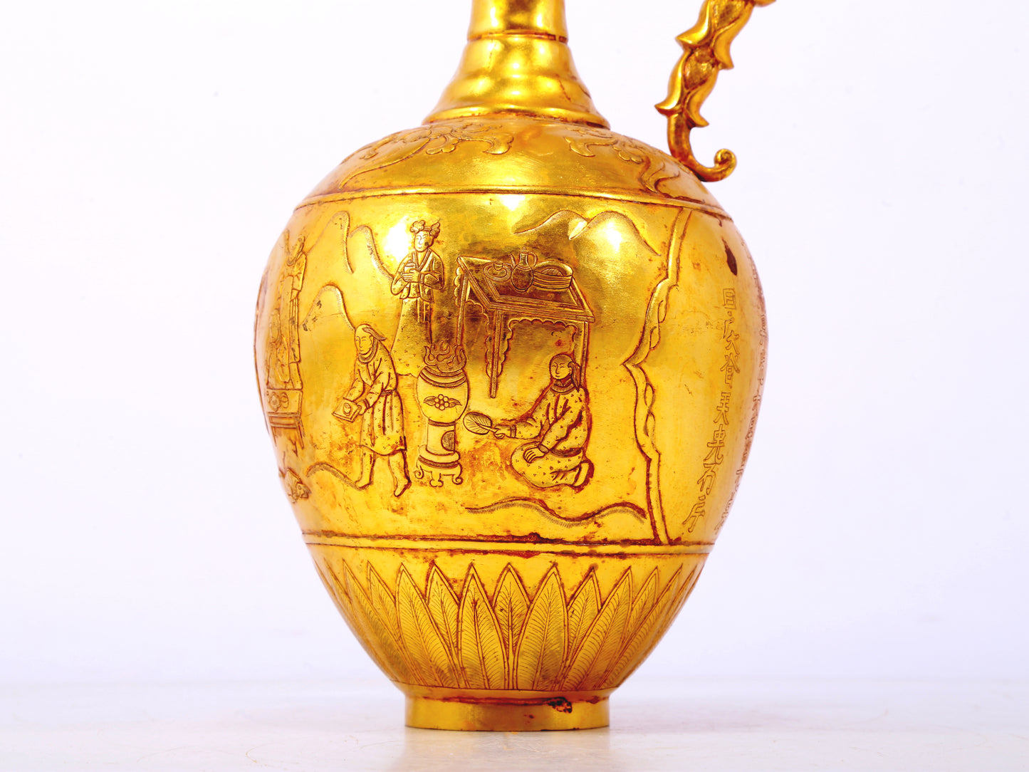 An exquisite gilt bronze landscape figure holding a pot