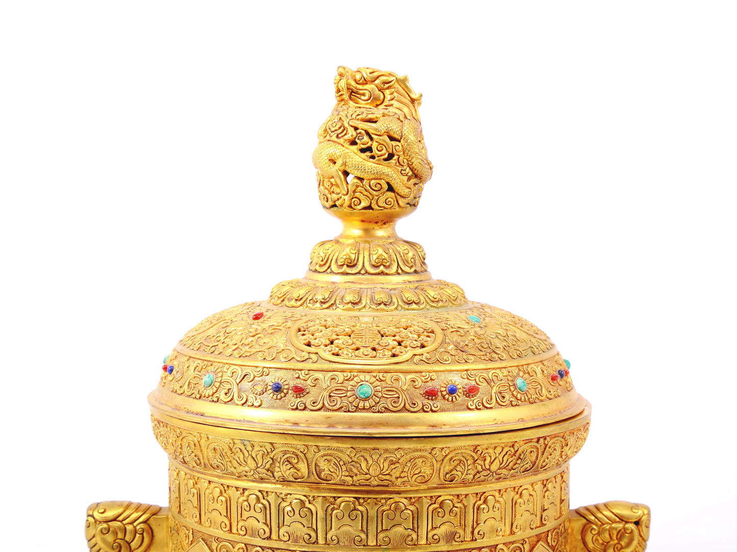 An exquisite gilt bronze double-eared tripod jar with a lid inlaid with hundreds of treasures and entwined lotus patterns.