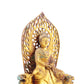 A serene gilt bronze statue of Gautama Buddha