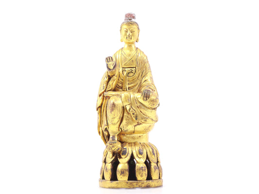 A serene gilt bronze statue of Gautama Buddha