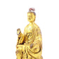 A serene gilt bronze statue of Gautama Buddha