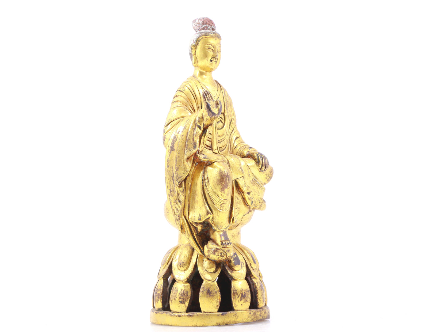 A serene gilt bronze statue of Gautama Buddha