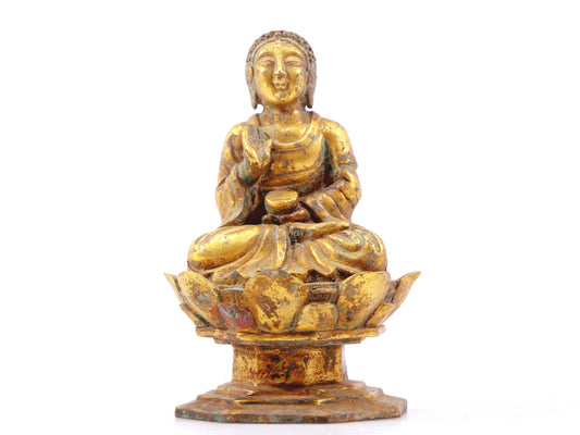 A serene gilt bronze statue of Gautama Buddha