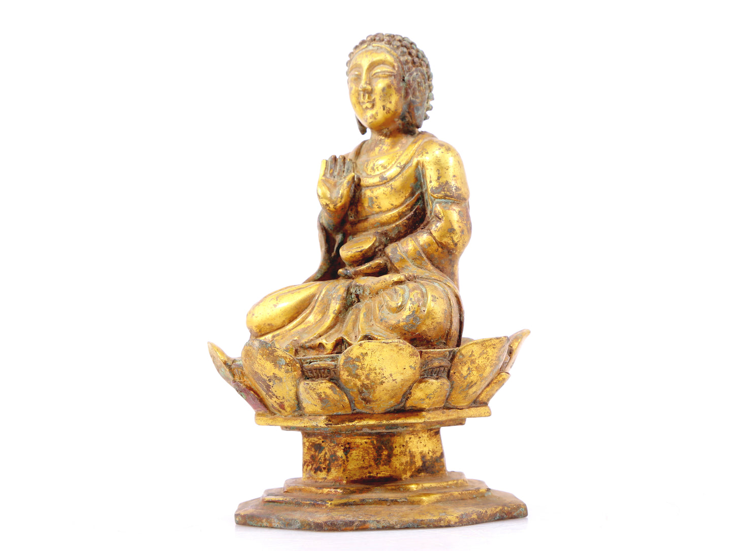 A serene gilt bronze statue of Gautama Buddha