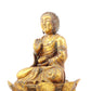 A serene gilt bronze statue of Gautama Buddha