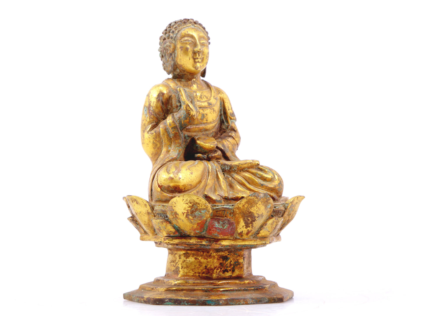 A serene gilt bronze statue of Gautama Buddha