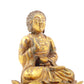 A serene gilt bronze statue of Gautama Buddha