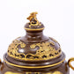 An exquisite gilt copper double-eared and tripod stove with 'auspicious clouds and chilong' patterns and a lid.