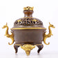 An exquisite gilt copper double-eared and tripod stove with 'auspicious clouds and chilong' patterns and a lid.