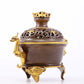 An exquisite gilt copper double-eared and tripod stove with 'auspicious clouds and chilong' patterns and a lid.