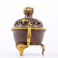 An exquisite gilt copper double-eared and tripod stove with 'auspicious clouds and chilong' patterns and a lid.