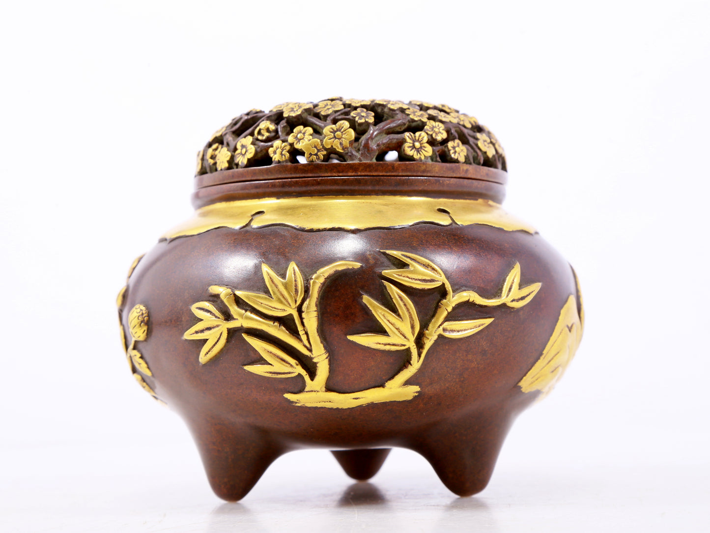 An exquisite gilt copper tripod censer with floral patterns