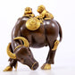 An exquisite gilt bronze boy herding cows