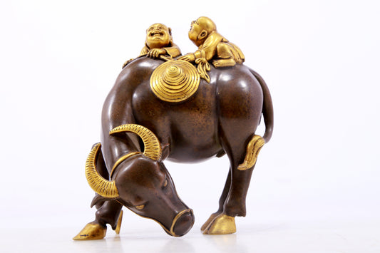 An exquisite gilt bronze boy herding cows