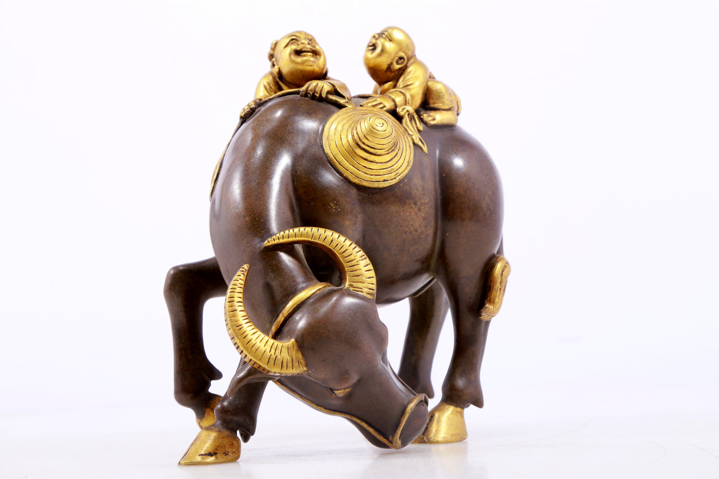 An exquisite gilt bronze boy herding cows