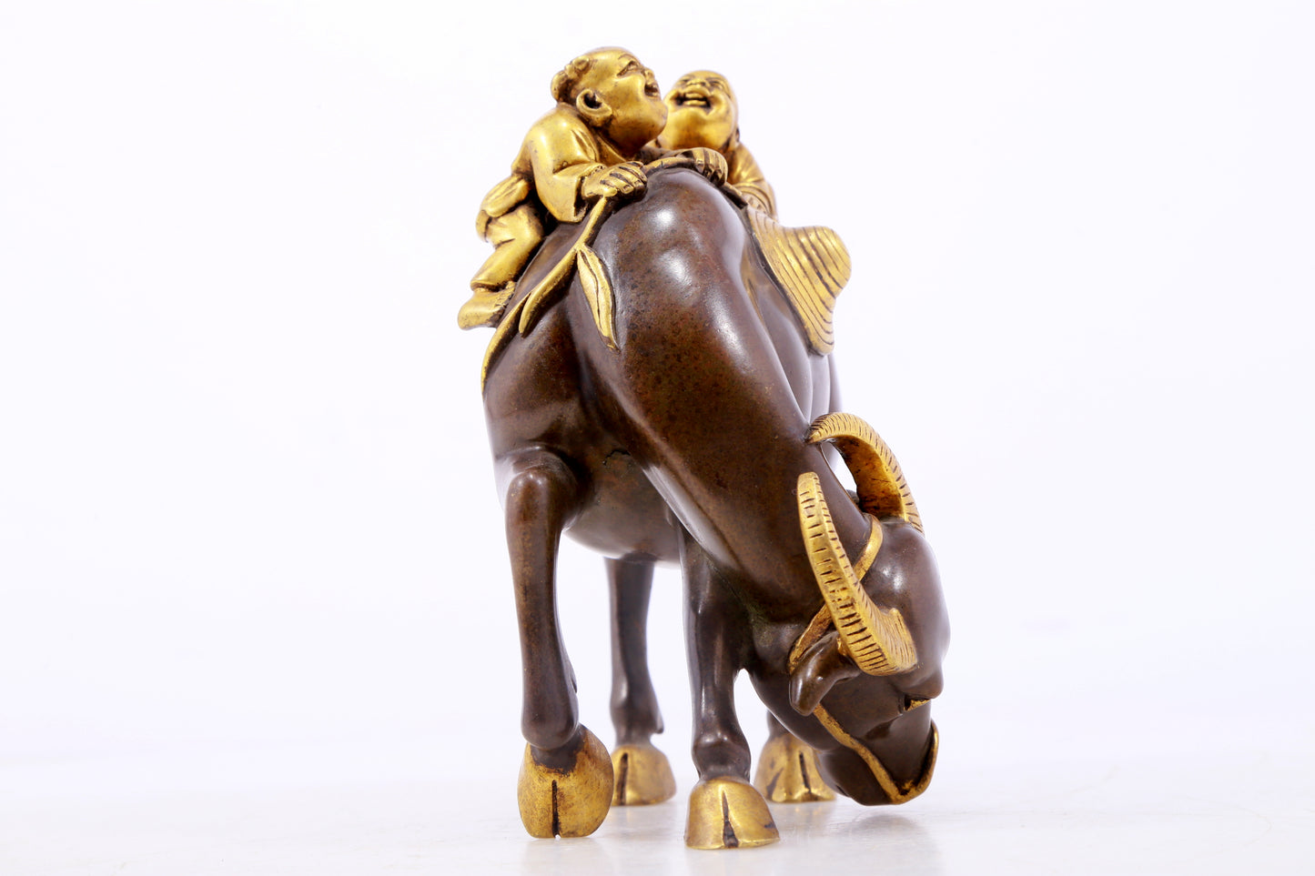 An exquisite gilt bronze boy herding cows