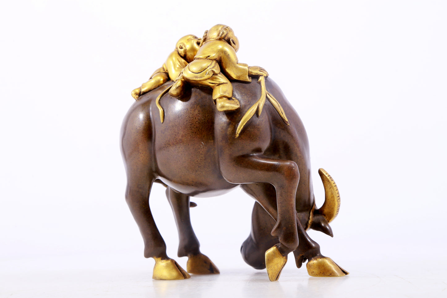 An exquisite gilt bronze boy herding cows