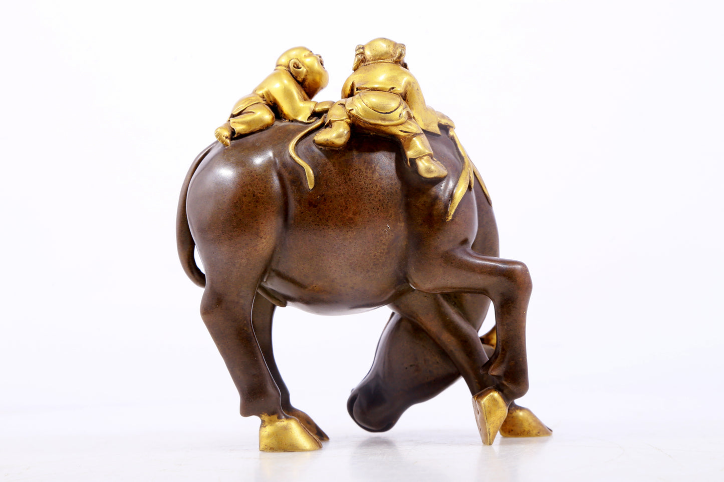 An exquisite gilt bronze boy herding cows