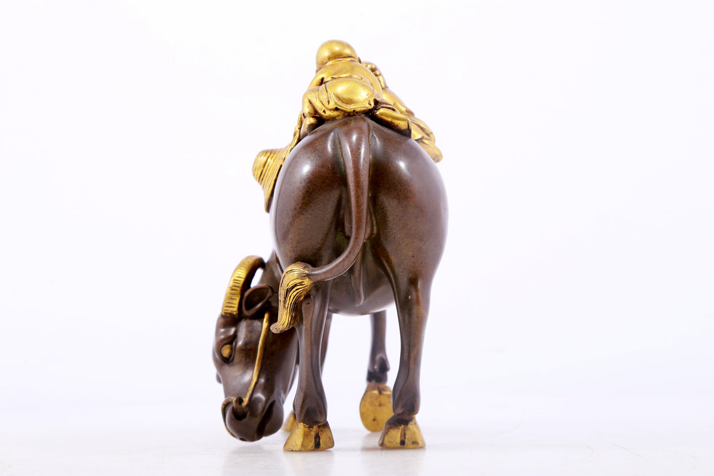 An exquisite gilt bronze boy herding cows