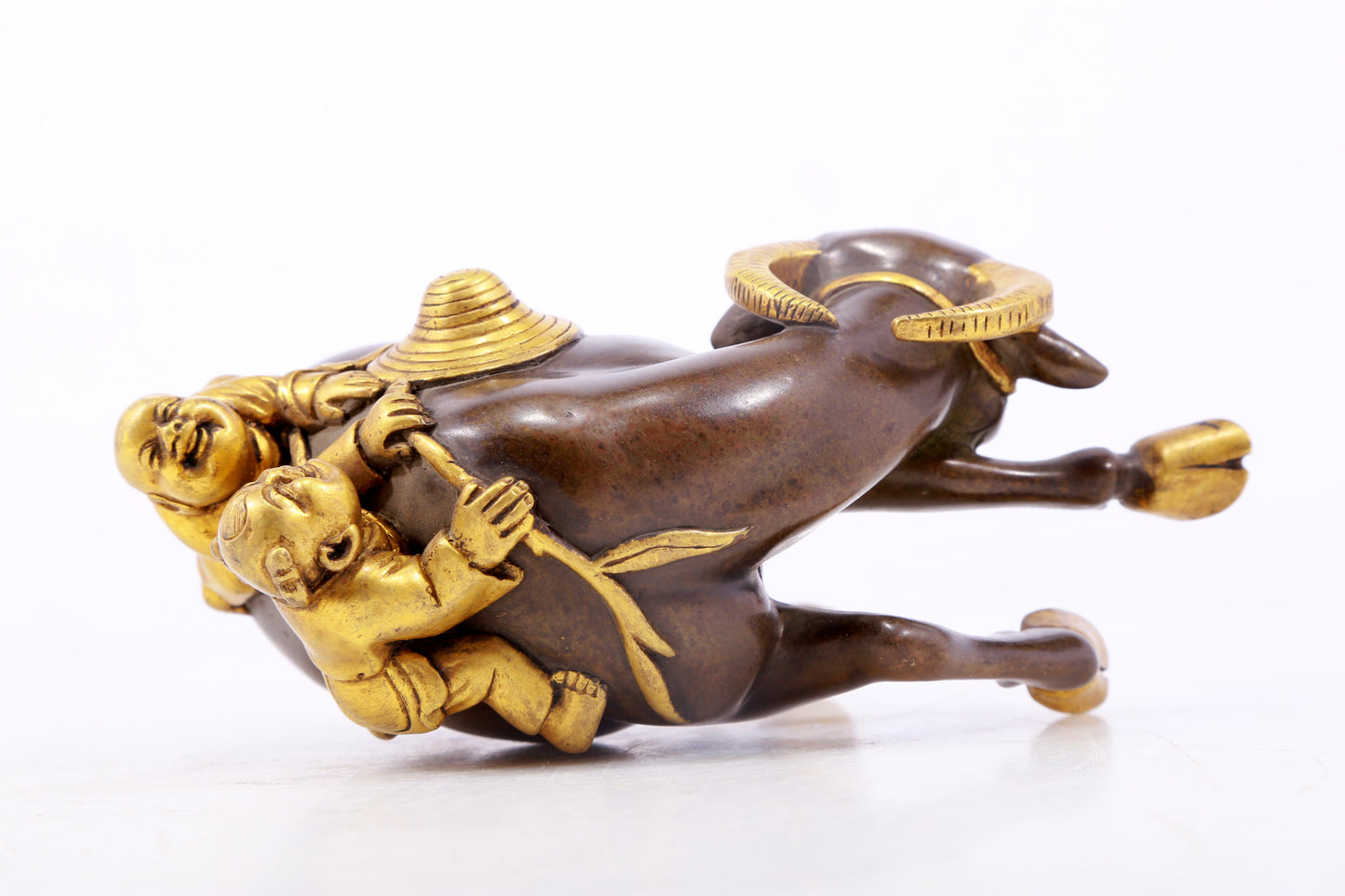 An exquisite gilt bronze boy herding cows