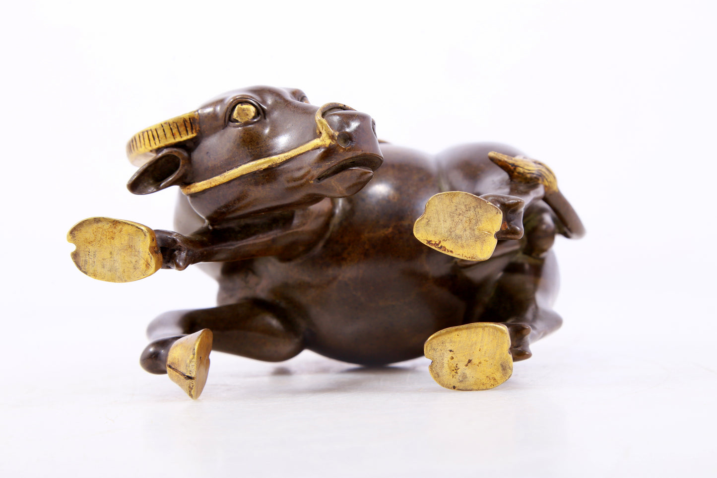 An exquisite gilt bronze boy herding cows