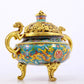 An exquisite cloisonné 'lily and dragon' pattern two-eared tripod censer with lid