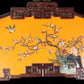 An exquisite lacquered huanghuali wood hanging screen with flower and bird patterns inlaid with gemstones