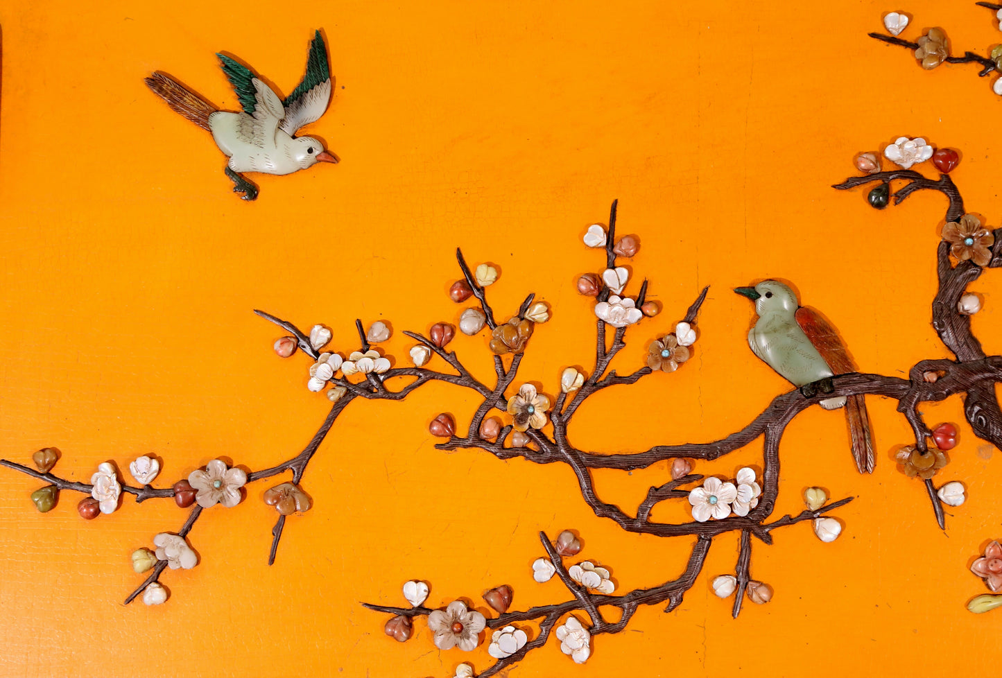 An exquisite lacquered huanghuali wood hanging screen with flower and bird patterns inlaid with gemstones