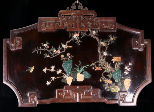 An exquisite lacquered huanghuali wood hanging screen with flower and bird patterns inlaid with gemstones