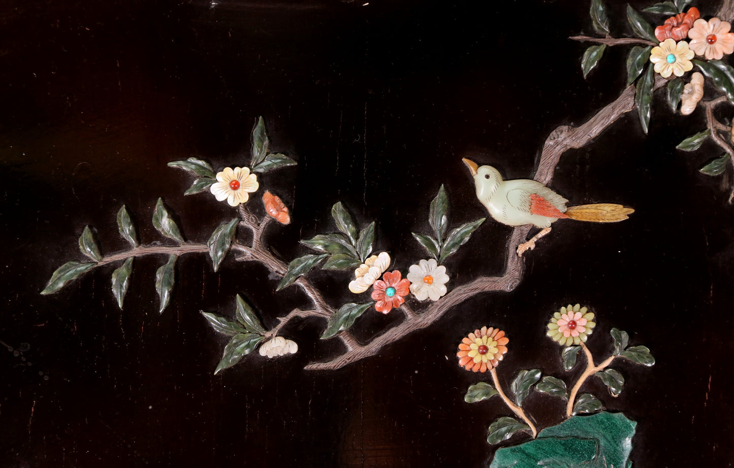 An exquisite lacquered huanghuali wood hanging screen with flower and bird patterns inlaid with gemstones